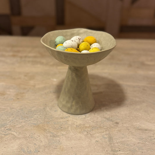 een handgemaakte standaard voorzien van een matte glazuur met paaseitjes