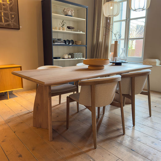 rose stoel van eikenhout en stof zonder armleuning bij een houten tafel